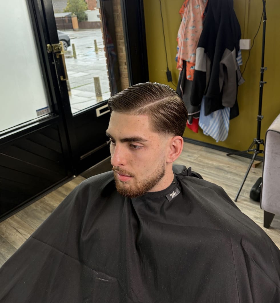 A classic side-parted haircut with a taper fade at Kennedys