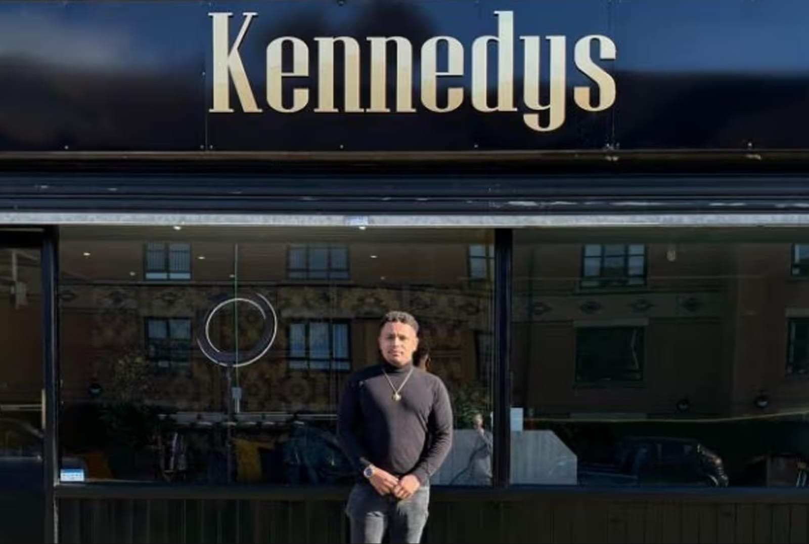Brandon Kennedy outside the black and gold Kennedys shopfront